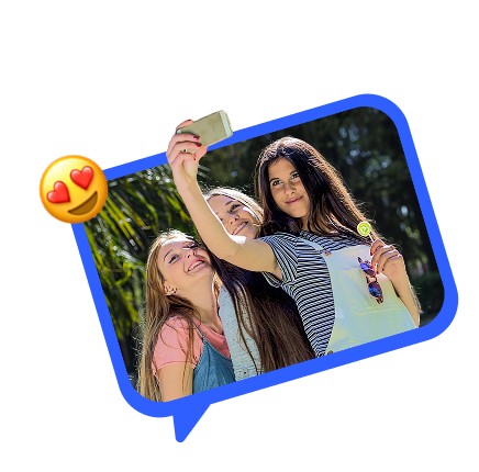 young women outside taking selfies together