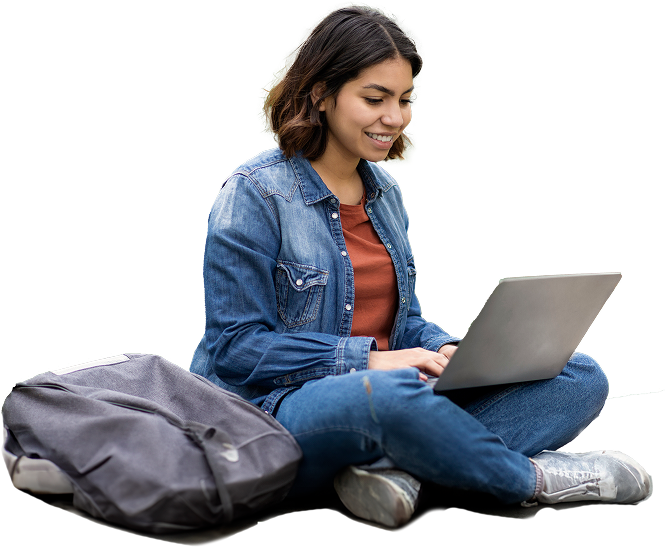 young woman sitting cross-legged while using a laptop in her lap