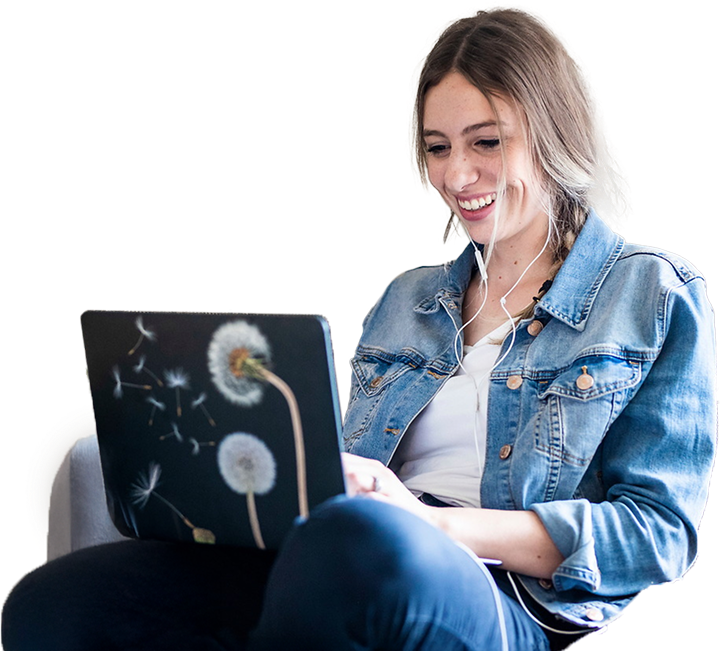 young woman sitting down using a laptop in her lap